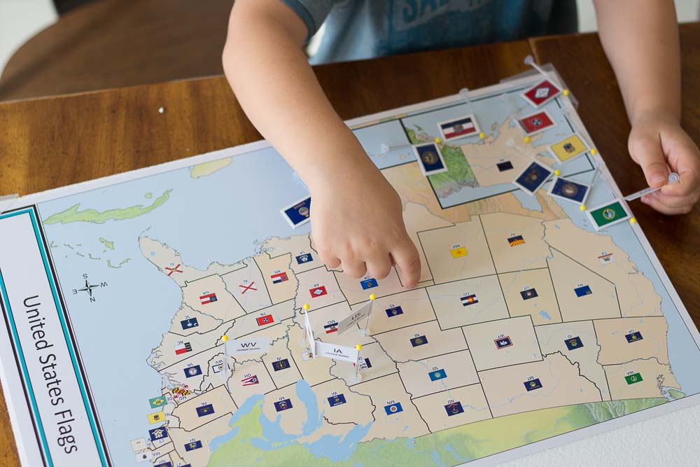 A close up of the homeschool geography curriculum with the state flags marked.