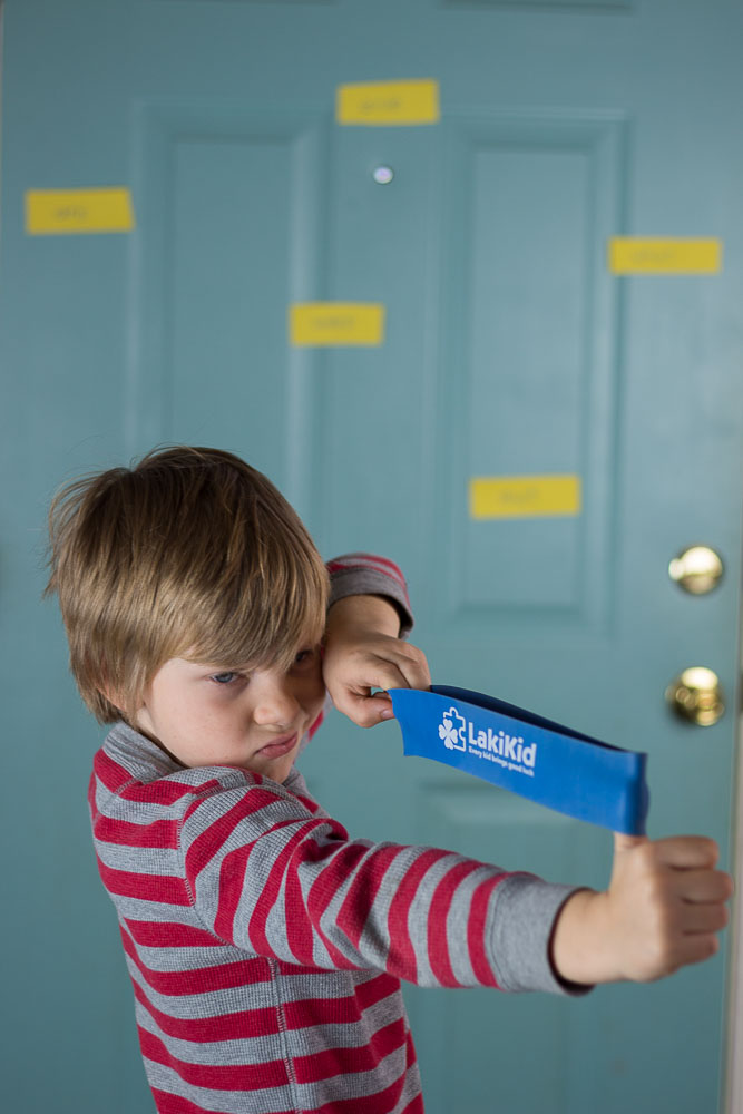 Picture of a boy pulling a large rubber band back and aiming at sight words. 