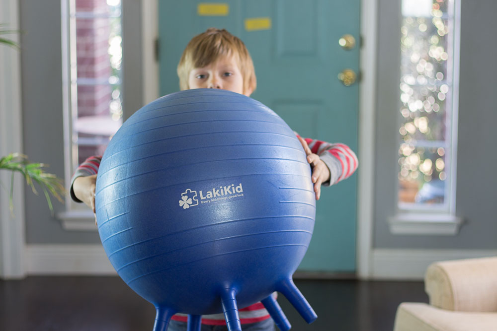 another image of the child holding the ball with the ball in focus. 